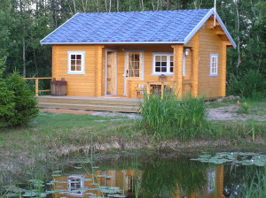Sauna house with lounge area by a pond